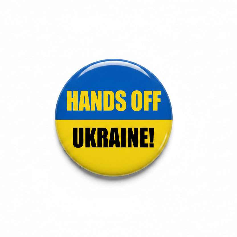 Pinback button with black rim and blue-yellow circle reading "HANDS OFF UKRAINE!"