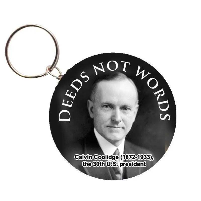 Round keychain with Calvin Coolidge portrait and 'DEEDS NOT WORDS'.