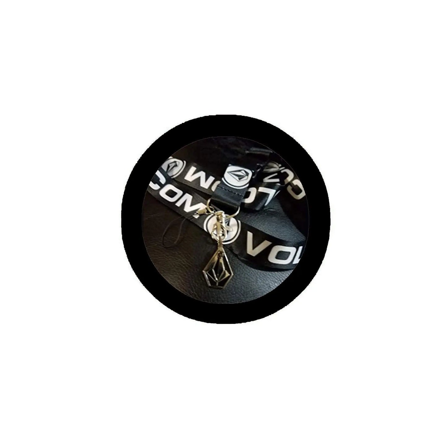 Black keychain lanyard with metal charm and lobster clasp, shown in a circular holder