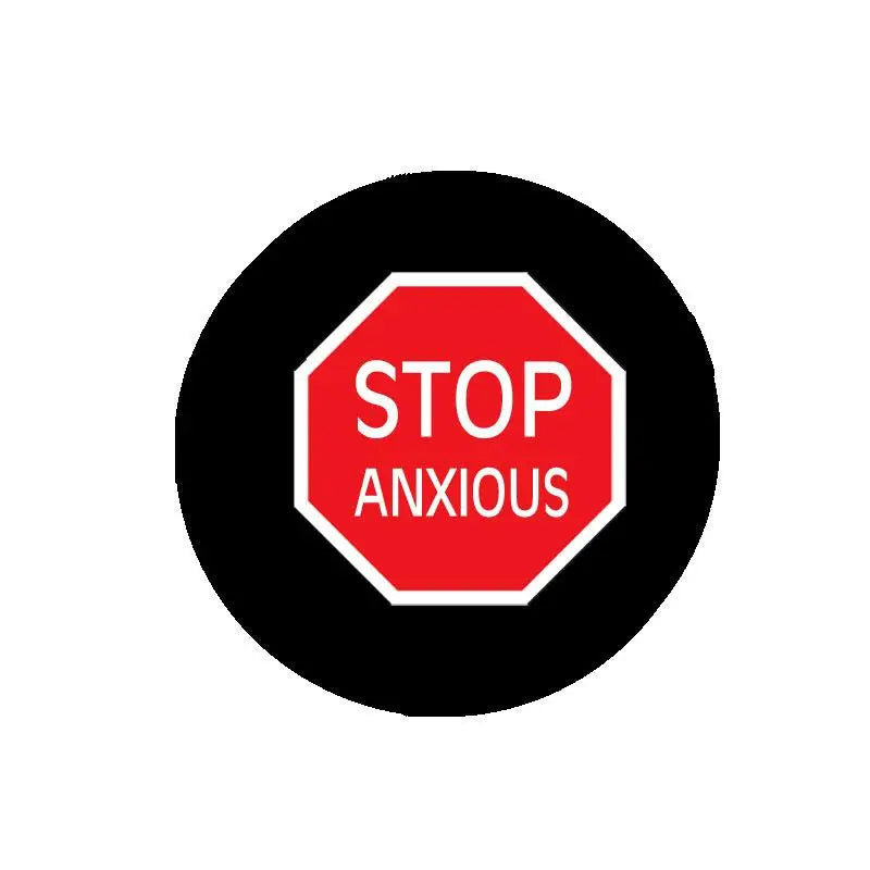 Round black pinback brooch with red STOP ANXIOUS octagon design