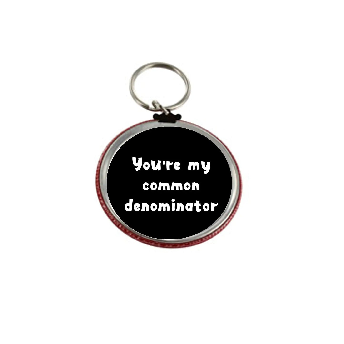 2.25-inch round keychain holder, black with red edge, text: 'You're my common denominator'