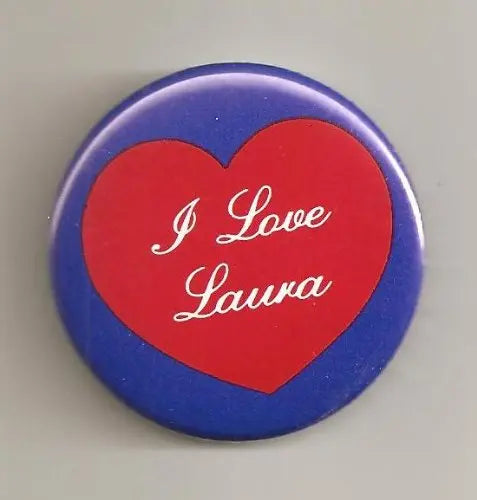 Round pinback button with blue border and red heart reading "I Love Laura"