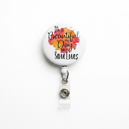 Retractable badge reel, white round face with “Beautiful Day to Save Lives” print