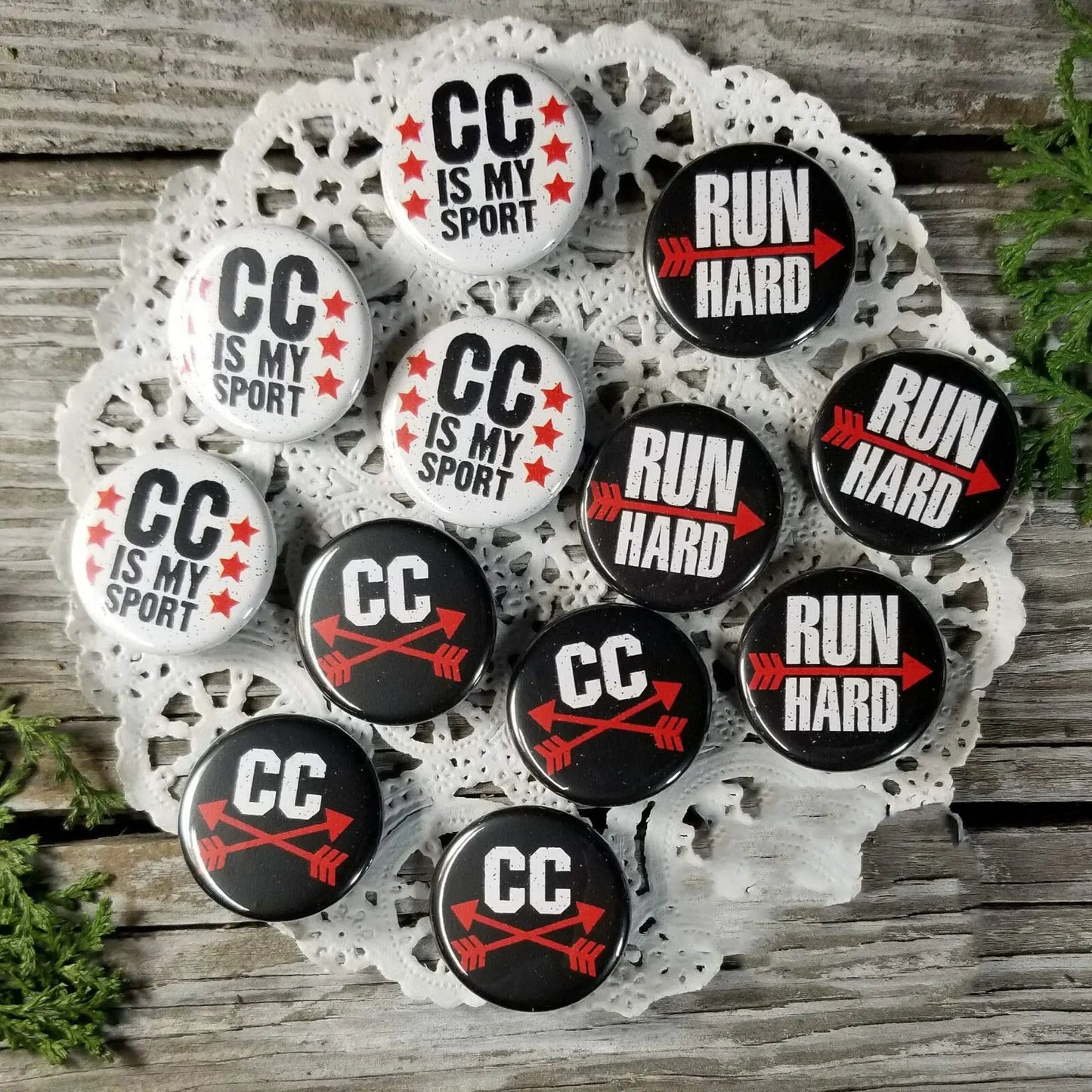 Round pinback badge set in tray with CC IS MY SPORT and RUN HARD designs, red/black
