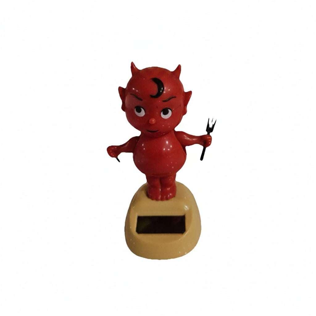 Solar-powered devil car ornament swing doll with red figurine on tan base and black solar panel