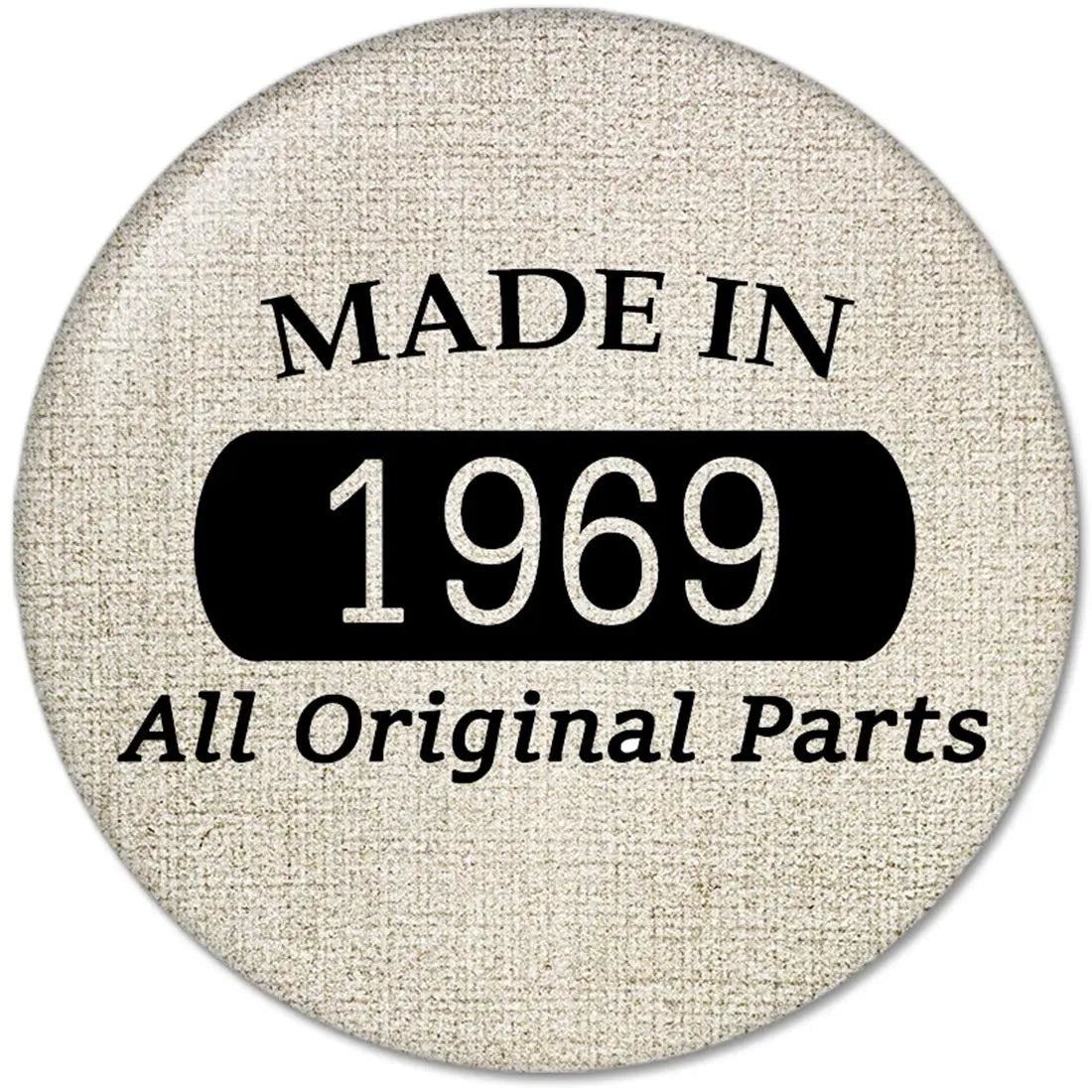 1969 pinback button with fabric-textured face, black banner reading 1969, Made in 1969