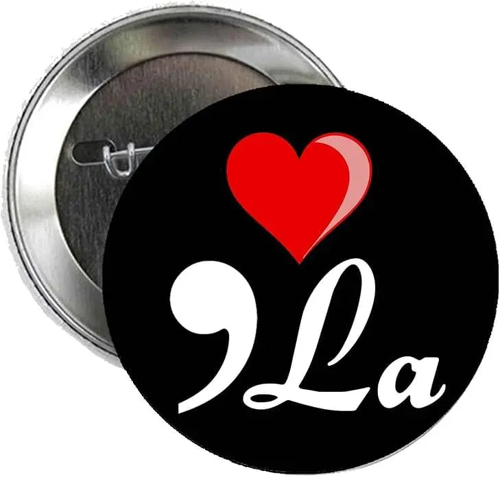Black pinback button with red heart and white cursive 'La' design