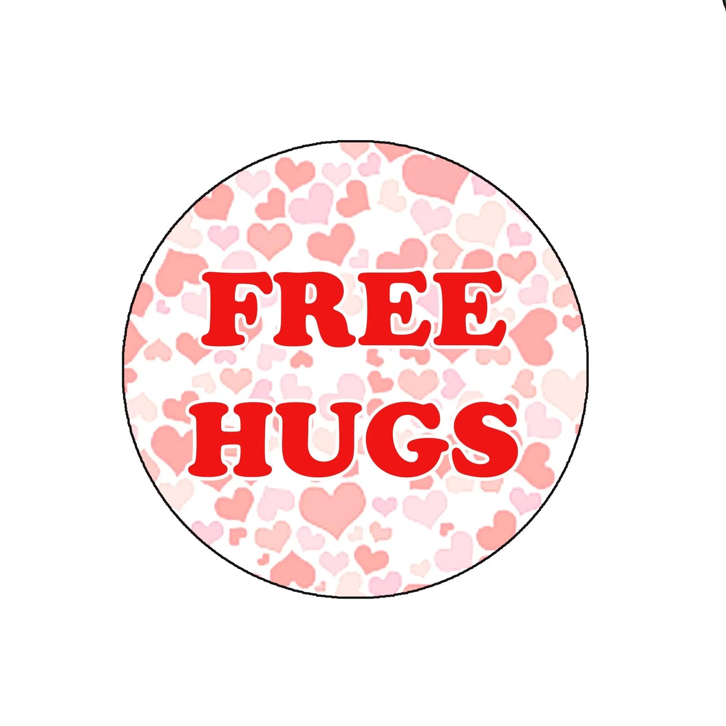 Round badge reel insert with “FREE HUGS” text on pink heart pattern