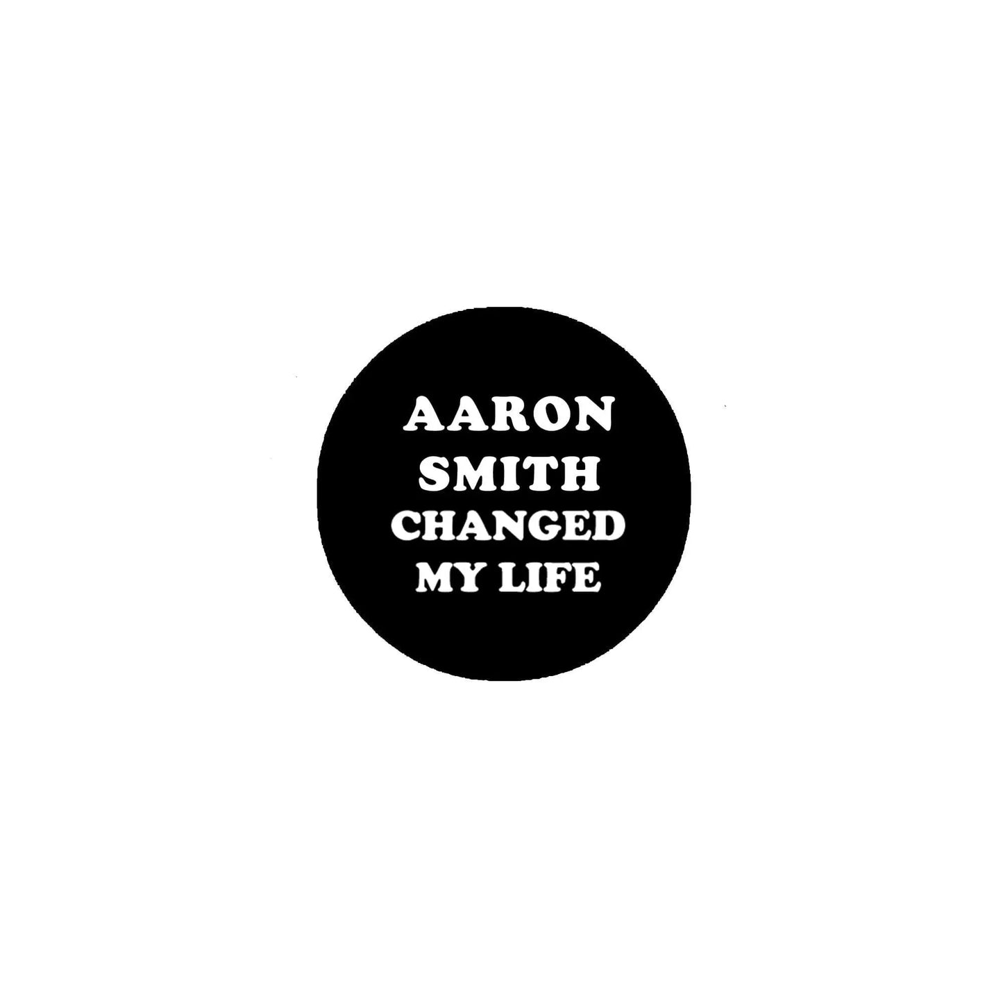 Round black pinback button with 'AARON SMITH CHANGED MY LIFE' text