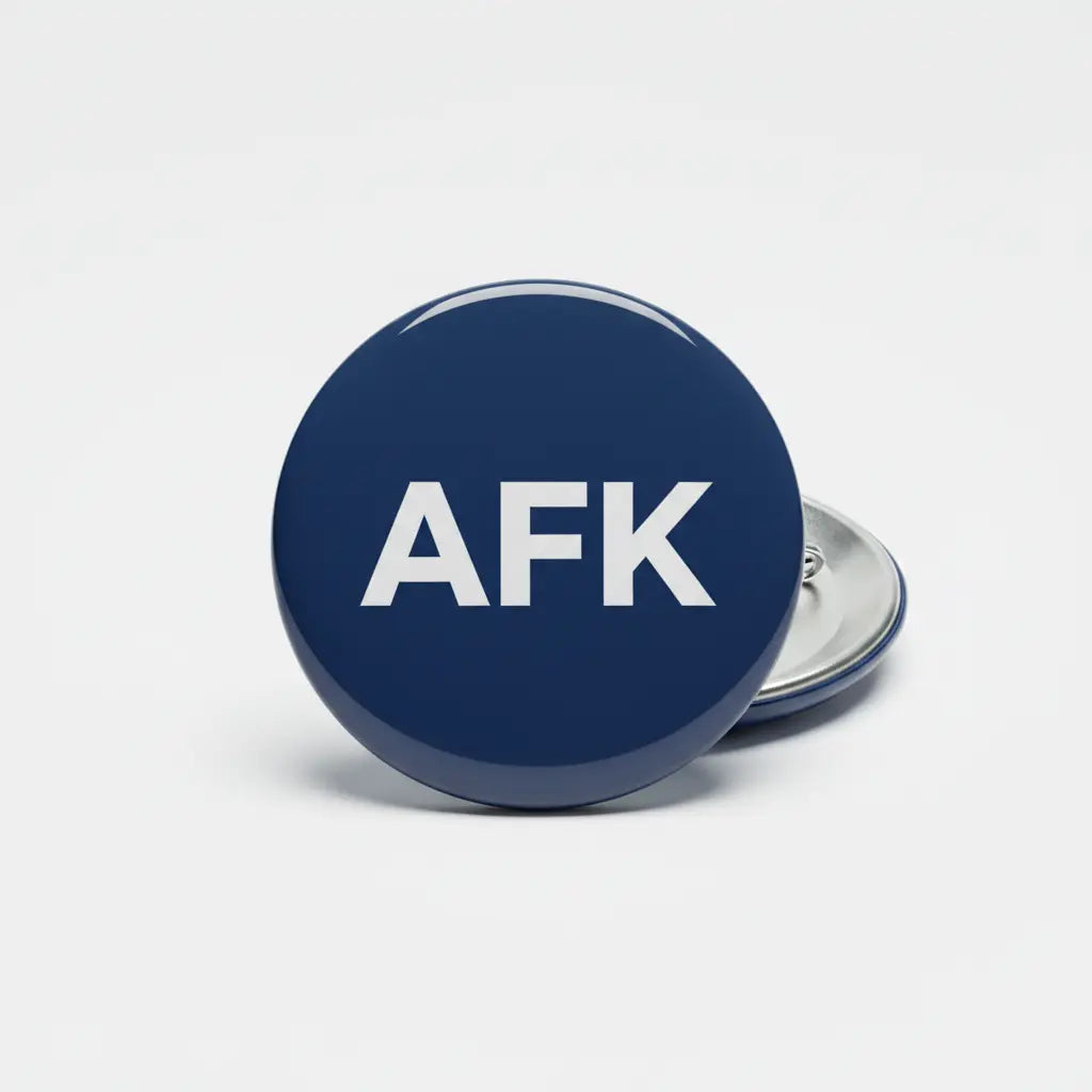 AFK pinback button, 2.25-inch, round navy front with AFK logo; silver clasp back visible