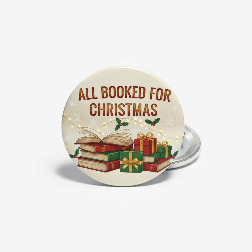 Round cream pinback button with 'ALL BOOKED FOR CHRISTMAS' text, books and gift icons