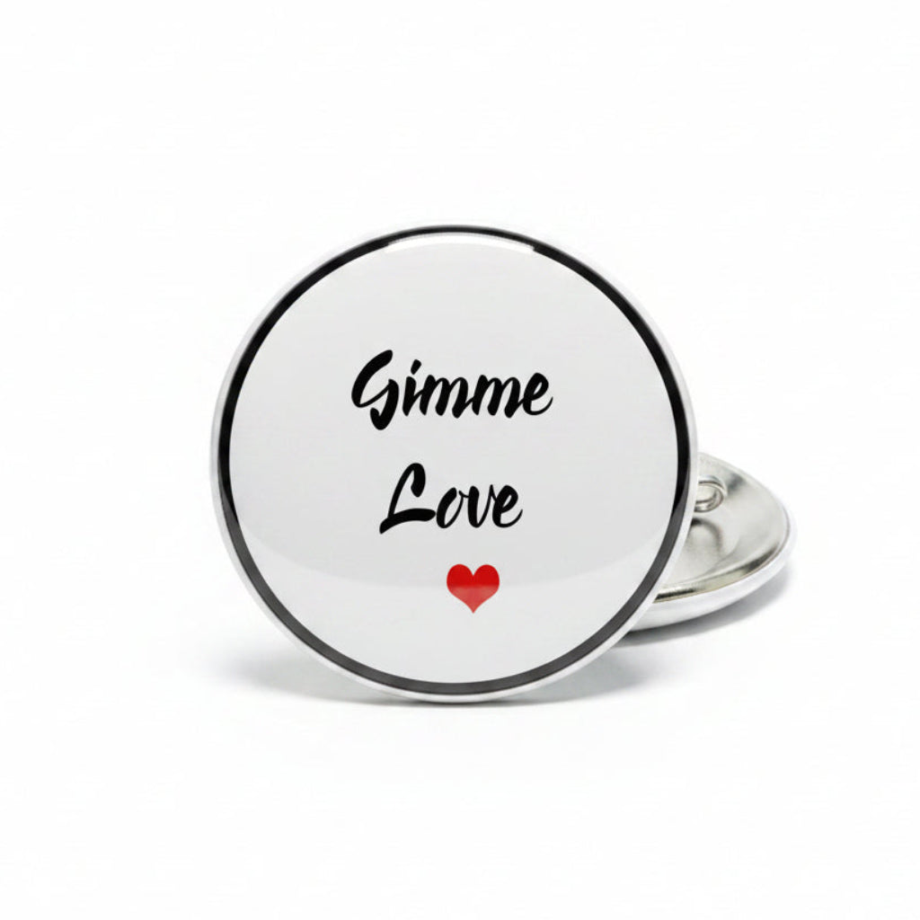 Gimme Love pin-back badge with white round face, black lettering, and red heart