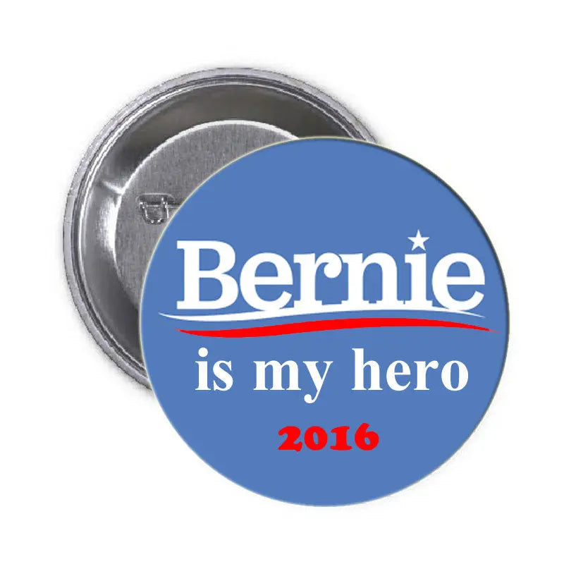 Blue round pinback badge reading 'Bernie is my hero' with star; metal clasp back
