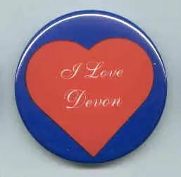 Heart-themed pinback button with blue rim and red heart featuring white 'I Love Devon' text