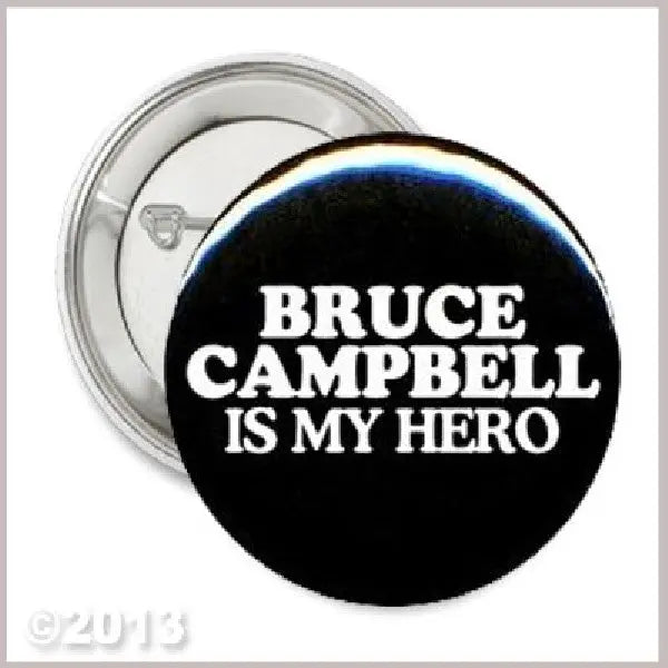 Pinback button: black circle with blue rim, "BRUCE CAMPBELL IS MY HERO" text