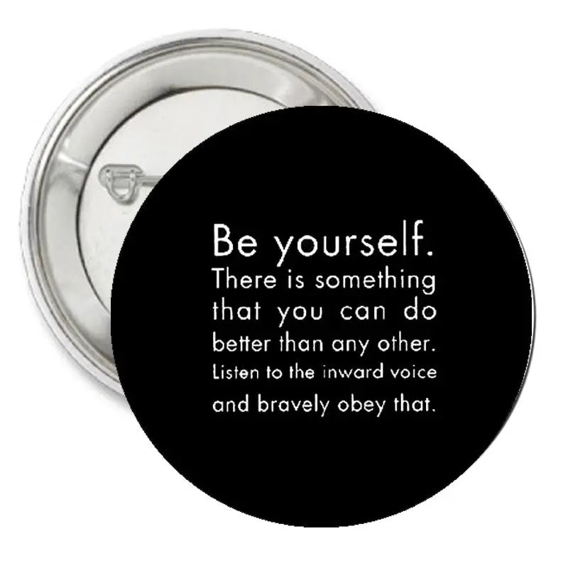 Black round pinback button with motivational quote text, 1.25-inch diameter