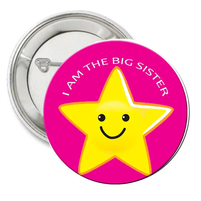 2.25-inch pinback badge, pink with yellow star face and “I AM THE BIG SISTER” text