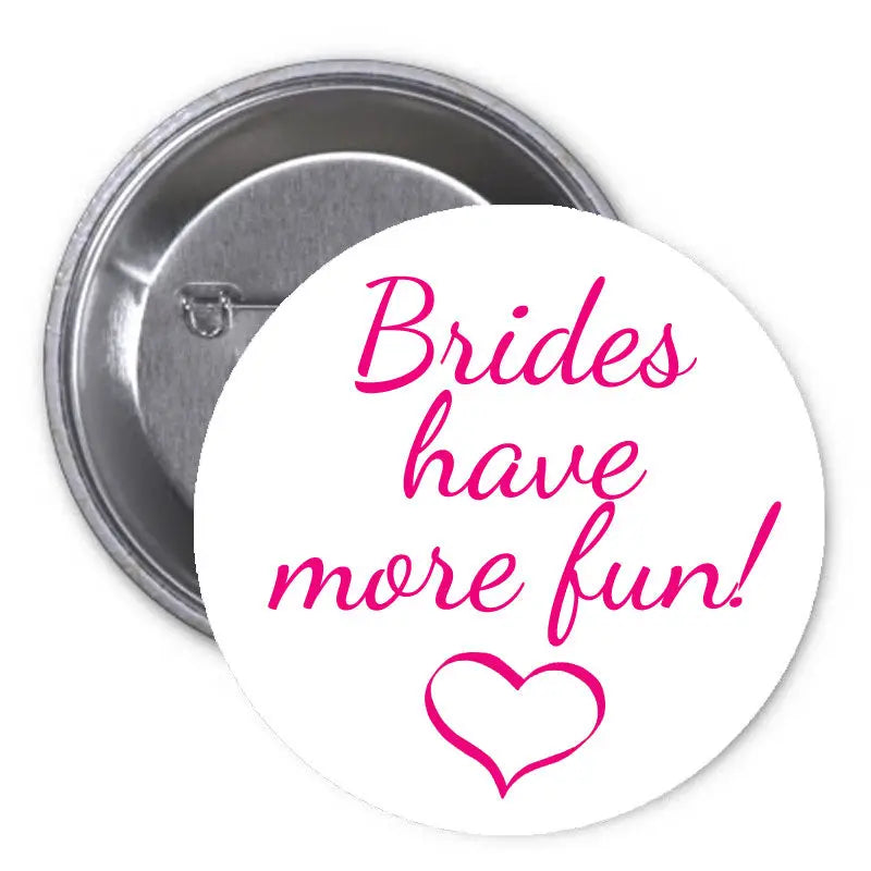 Round pinback button, white face with pink 'Brides have more fun!' and heart, metal back