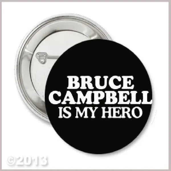 Round black button pin with white text: BRUCE CAMPBELL IS MY HERO