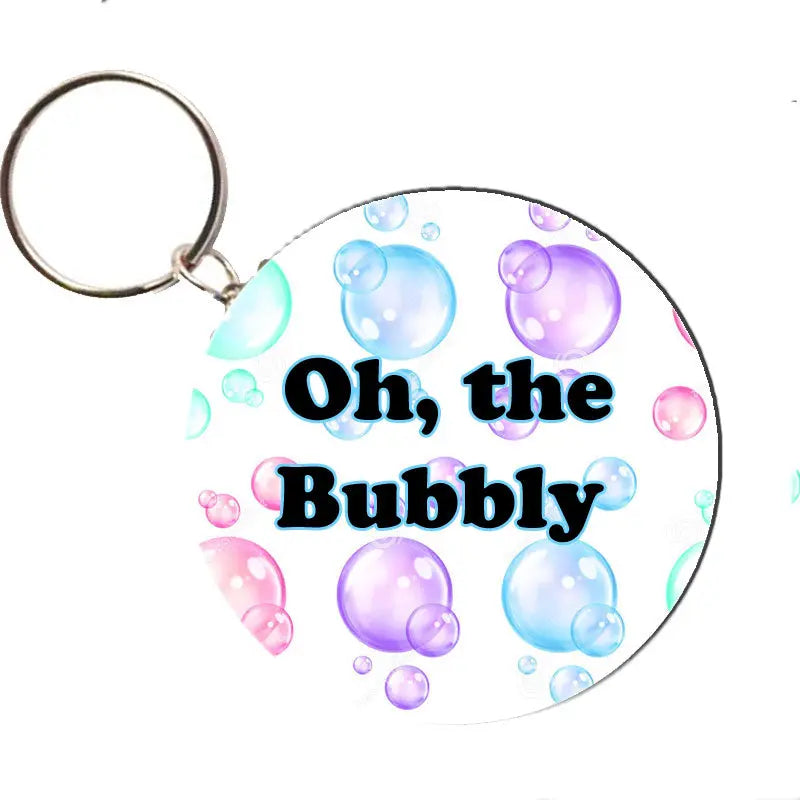 Round bubble-themed bottle opener keychain with metal ring, colorful 'Oh, the Bubbly' print