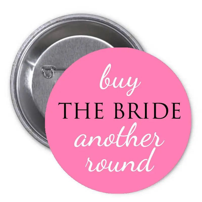 Pink pinback button: 'buy THE BRIDE another round' text on round face.