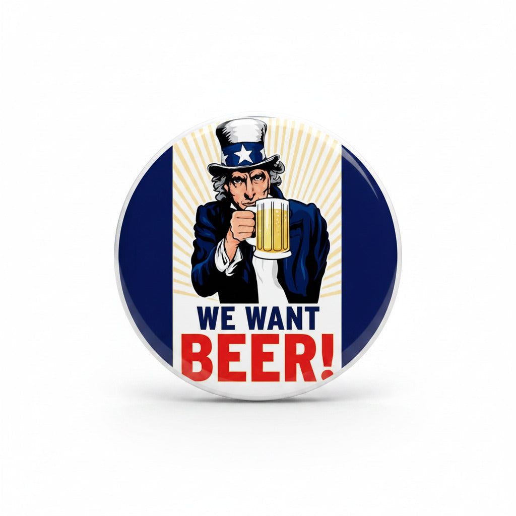 Beer pinback badge, round design with cartoon holding a mug and “WE WANT BEER!” text