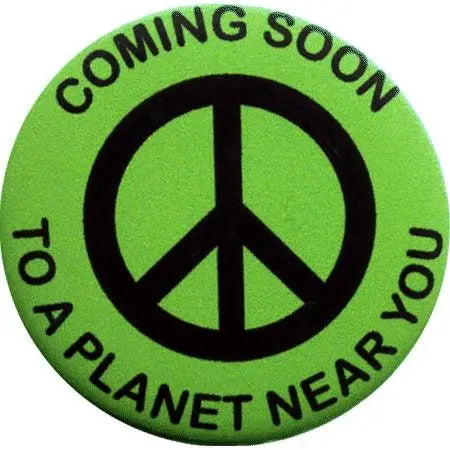2.25-inch green pinback button with black peace symbol and 'COMING SOON' text