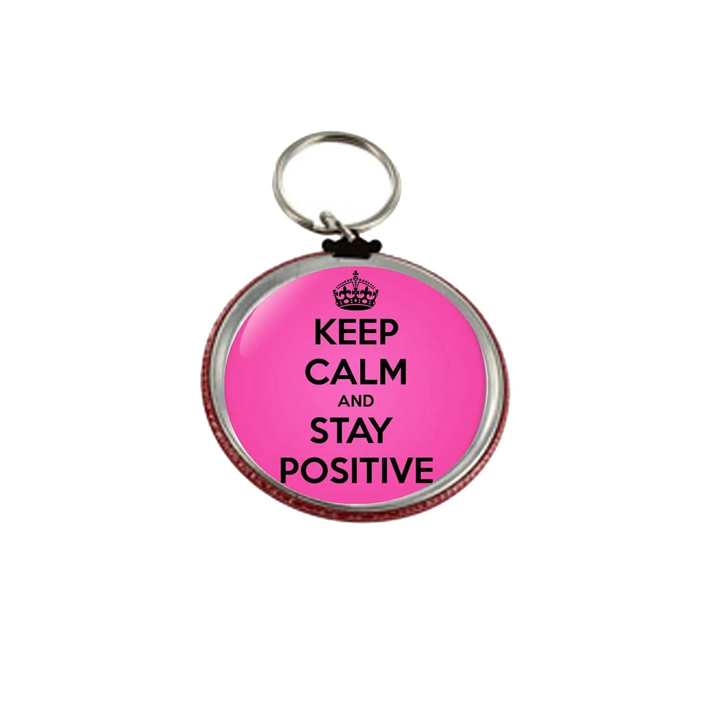 Pink round keychain with crown and 'KEEP CALM AND STAY POSITIVE' text