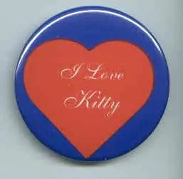 Heart-shaped pinback button with red heart and “I Love Kitty” text, blue rim