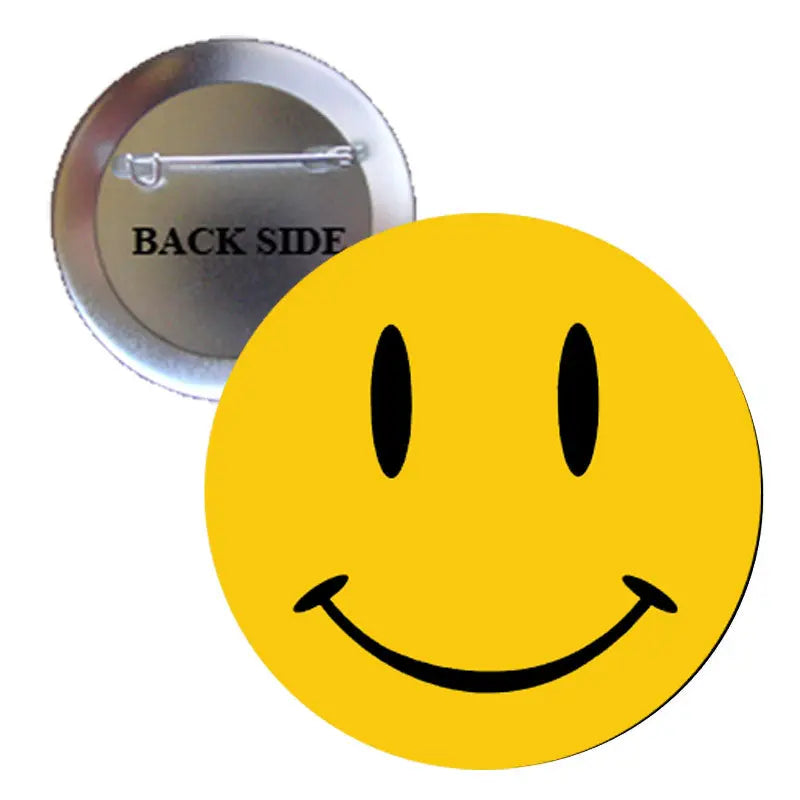 2.25-inch yellow smiley face pinback button with black features and metal safety pin