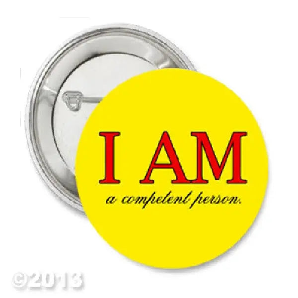 1.25-inch yellow pinback button: "I AM" and "a competent person" text