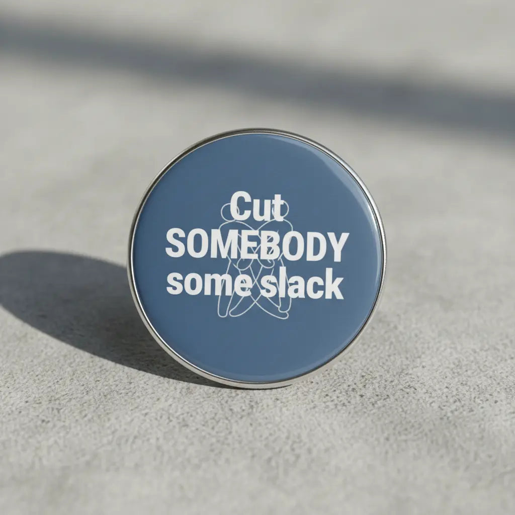 Round 2.25-inch pinback button with blue face and white slogan text