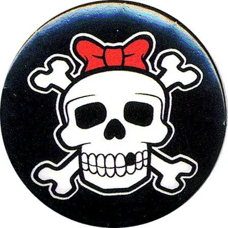 Round black patch with white skull and crossbones, red bow tie accent