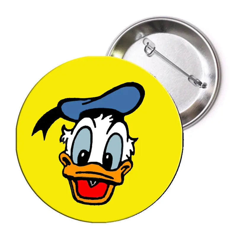 Yellow duck character pinback badge with round face graphic and metal safety pin back