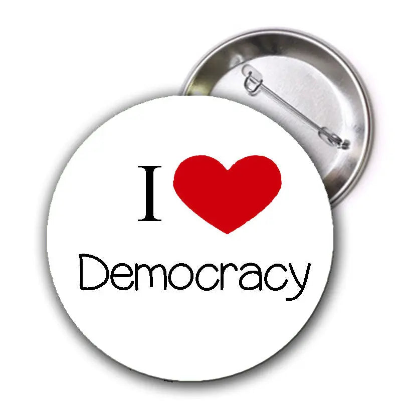 1.25-inch pinback button with white face, red heart, and black “I ♥ Democracy” text