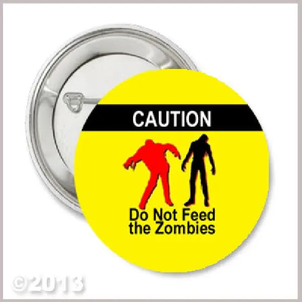1.25-inch pinback button with yellow caution graphic and zombie warning text