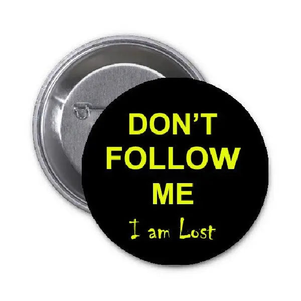 1.25-inch pinback button: black face with yellow 'DON'T FOLLOW ME' and 'I am Lost'