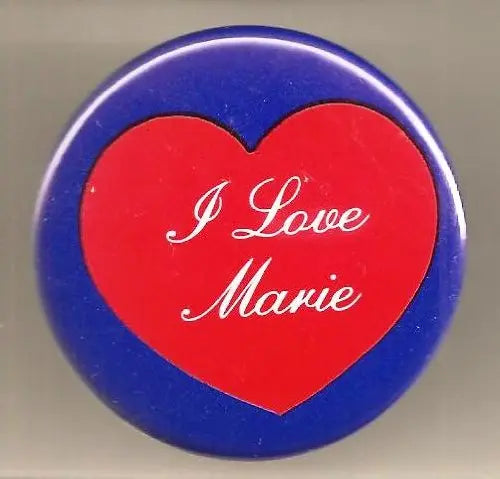 Round blue pinback button with red heart and white text 'I Love Marie'