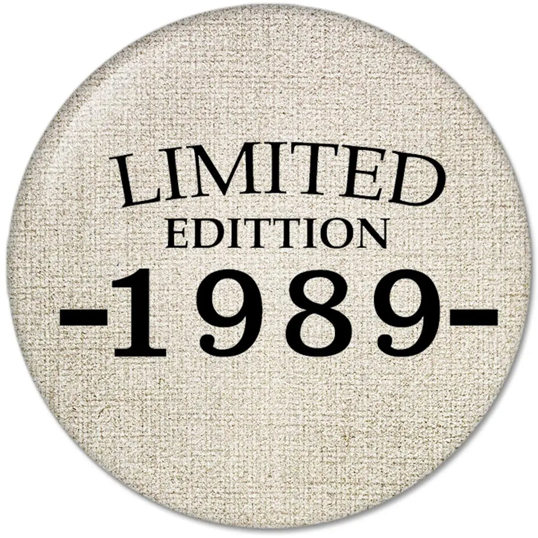 Round pinback button, beige fabric with black "LIMITED EDITION 1989-" text