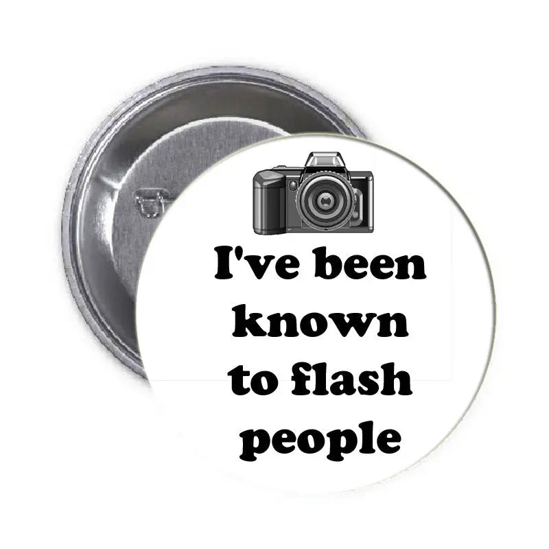 Round camera pinback with camera graphic and text: I've been known to flash people.
