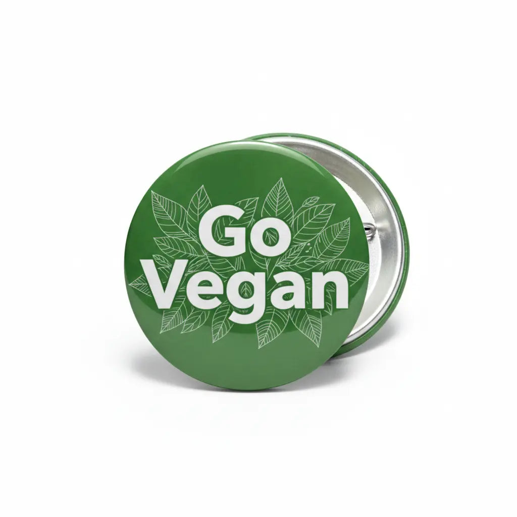 2.25-inch green Go Vegan round pin with leaf design and metal pinback
