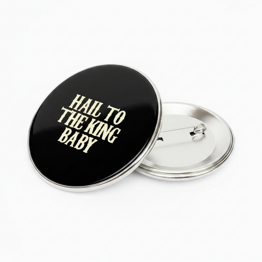 2.25-inch black pinback button with gold “Hail to the King Baby” and metal clasp