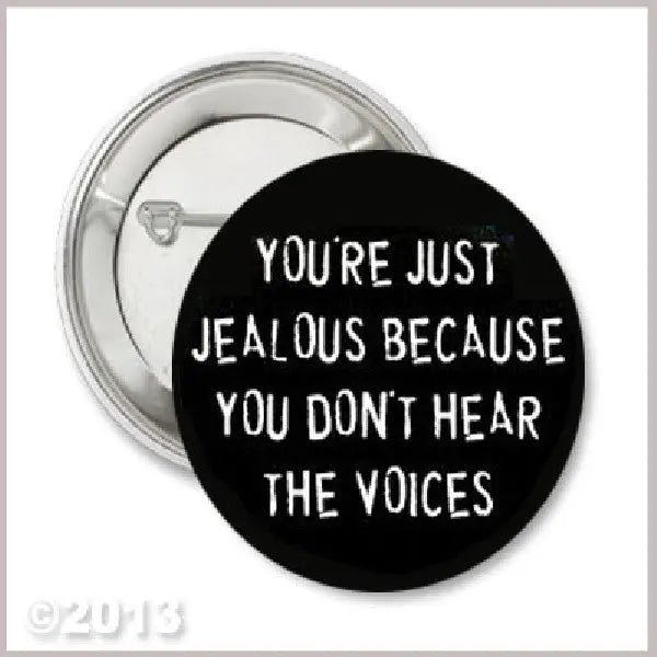 2.25-inch pinback button with black face and white text: “YOU'RE JUST JEALOUS BECAUSE…”