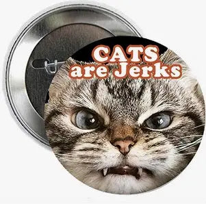 2.25-inch round cat pinback badge with “Cats are Jerks” text