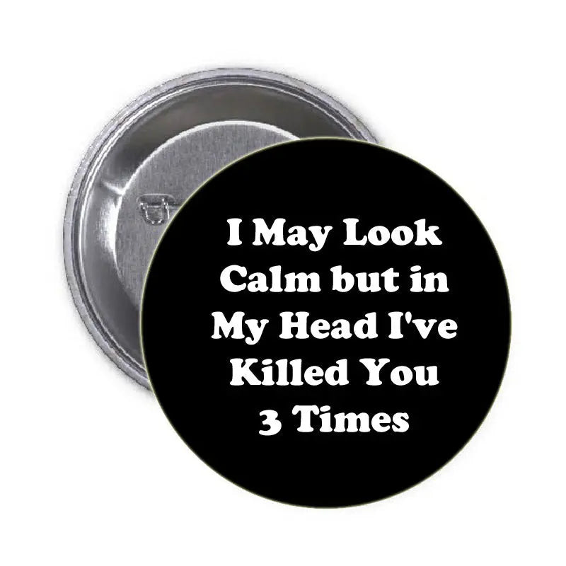 1.25-inch round black pinback button with white quote text and metal back