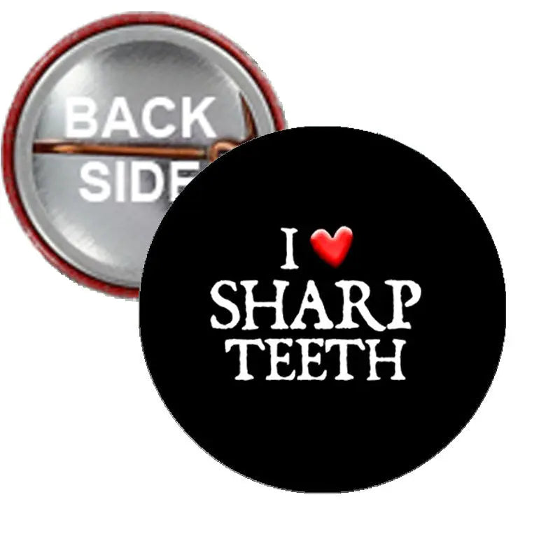 Black pinback button: 'I ♥ SHARP TEETH' lettering