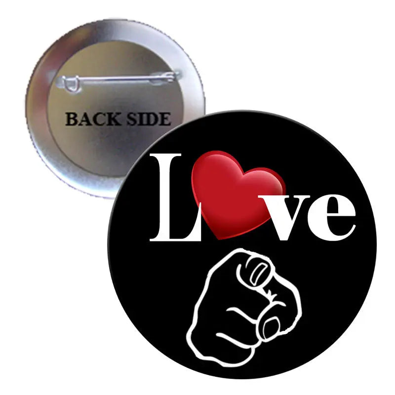 Pinback button: black face with heart and fist, silver back labeled 'BACK SIDE'