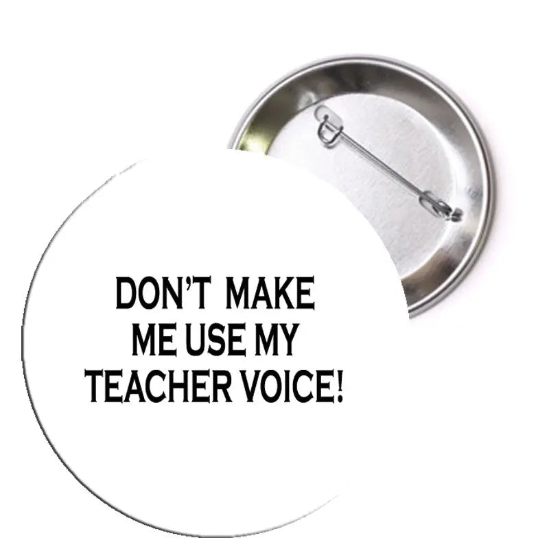 Round pinback button with black 'DON'T MAKE ME USE MY TEACHER VOICE!' text