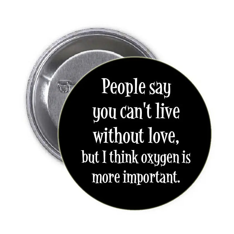 1.25-inch pinback button with black face and white quote text: "People say you can't live..."