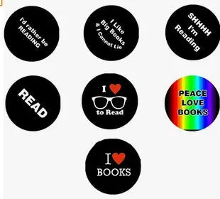 Set of seven round black book pinback buttons with READ, I ♥ BOOKS, and Peace Love Books